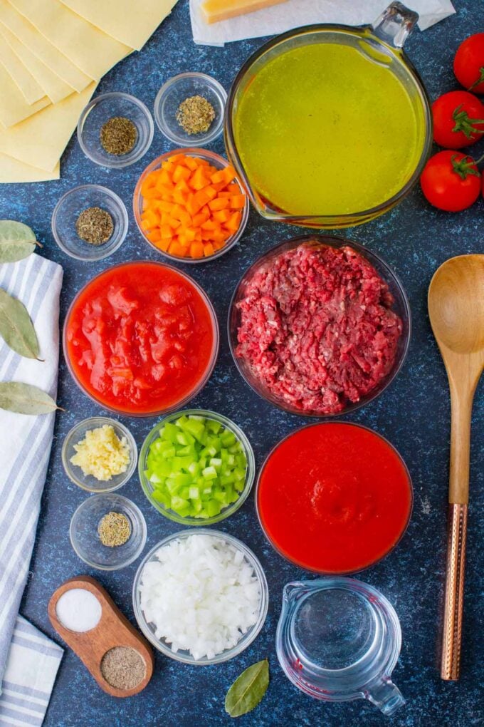 Overhead shot of Instant Pot lasagna soup ingredients in bowls on a table.