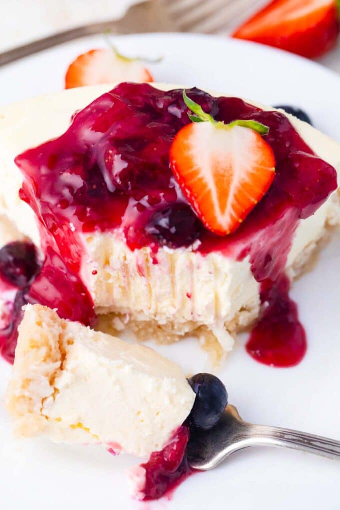Creamy keto cheesecake topped with low-carb berry sauce.