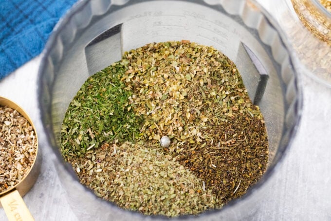 Homemade Italian seasoning blend ingredients in a food processor.