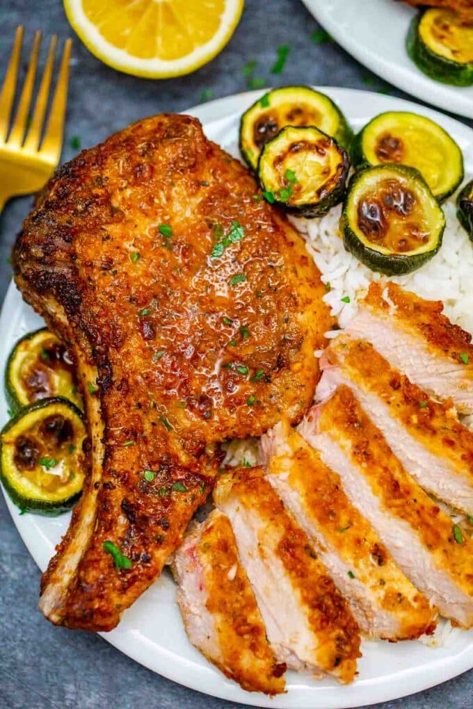 crispy §air fryer pork chops on a plate with zucchini