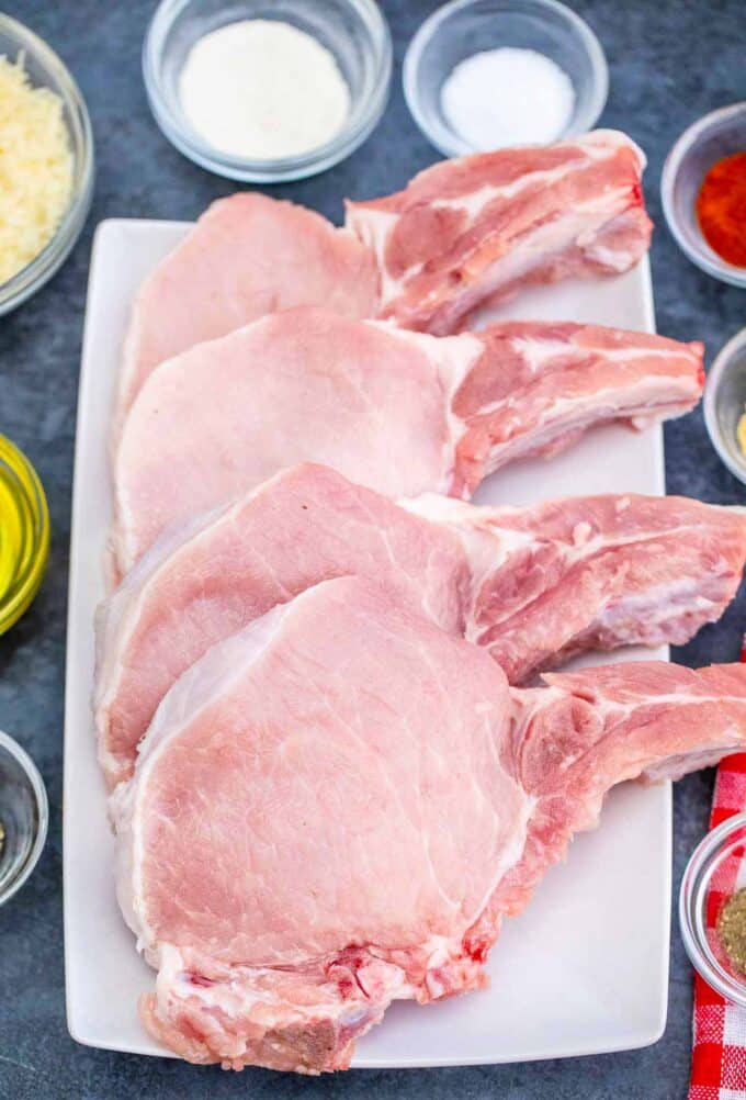 air fryer pork chops ingredients arranged in bowls on a plate