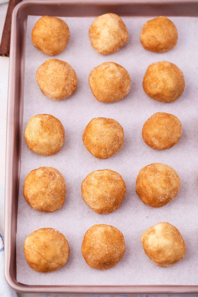 Cream cheese cookie balls on a baking tray.