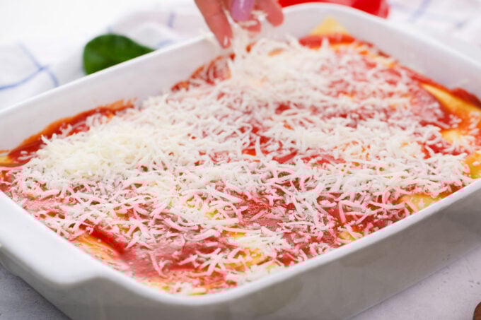 Layering chicken spinach lasagna.