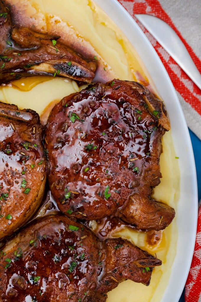Homemade baked brown sugar pork chops over mashed potatoes.