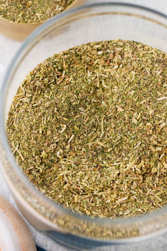 Homemade Italian seasoning in a glass jar.
