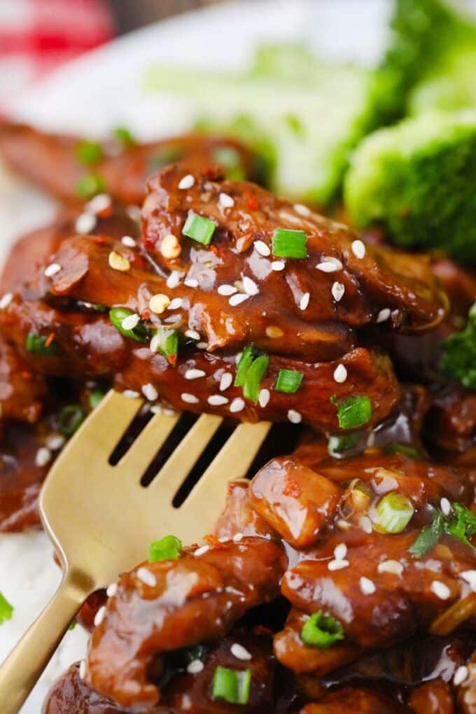 a forkful of tender general tso chicken