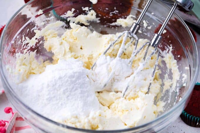 Cream cheese frosting ingredients in a bowl.