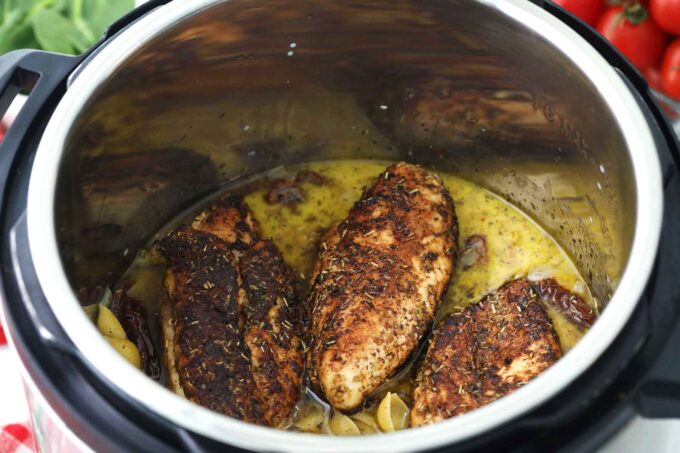 adding seared herbed chicken breast to the instant pot