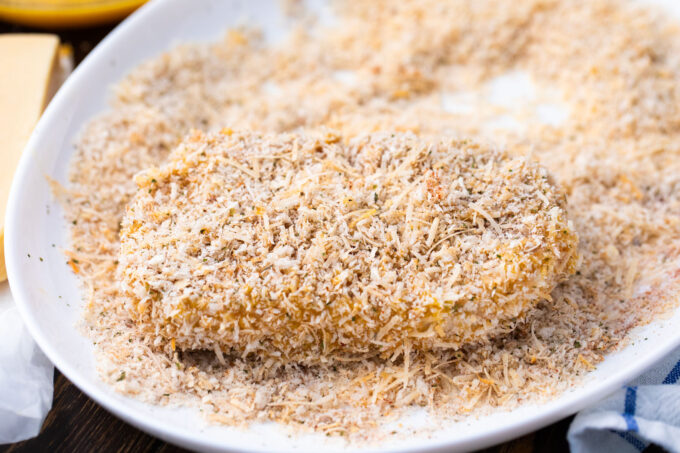 Tossing pork chop in Panko mixture.