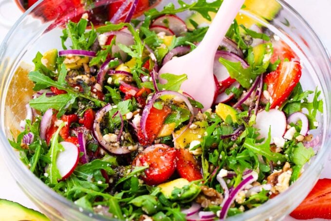 Strawberry arugula salad in a bowl.
