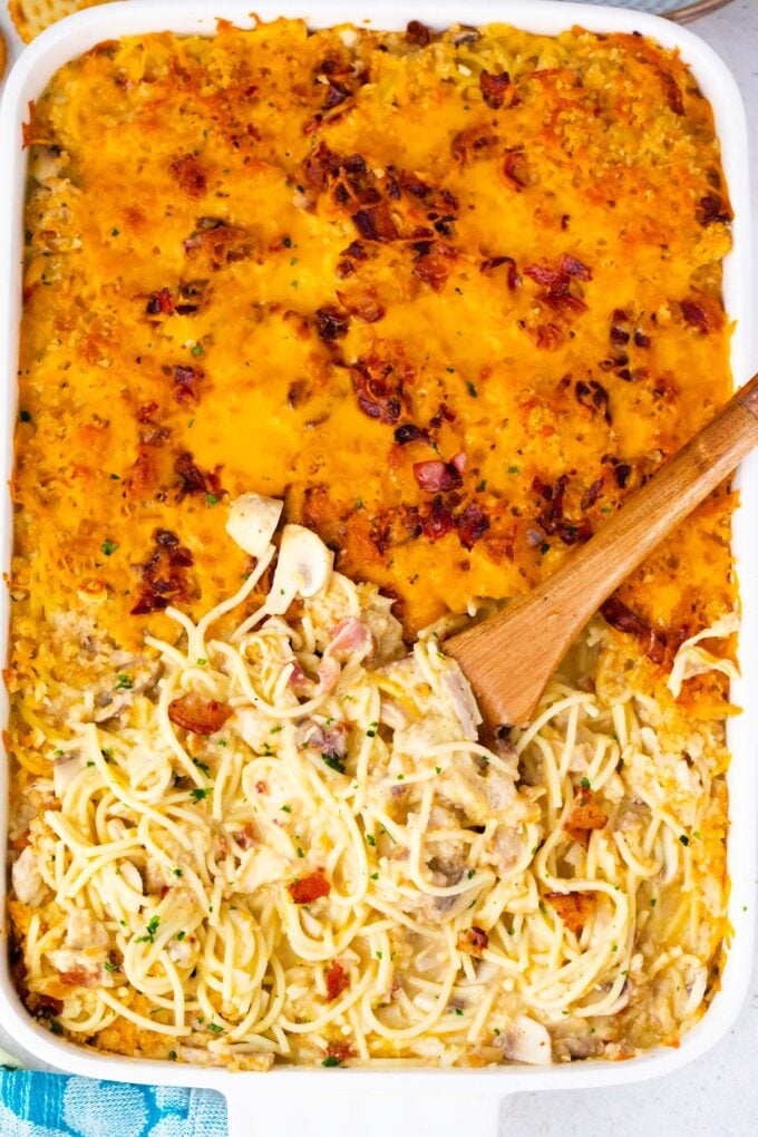 Overhead shot of crack chicken spaghetti casserole with buttery, cheesy topping.