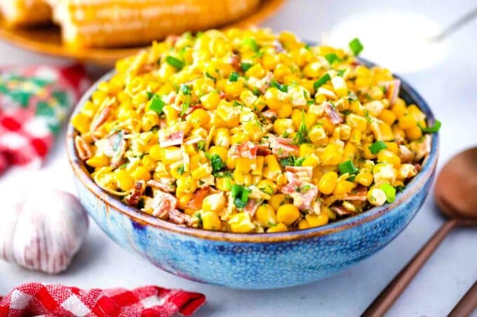 a bowl of crack corn salad with bacon bits