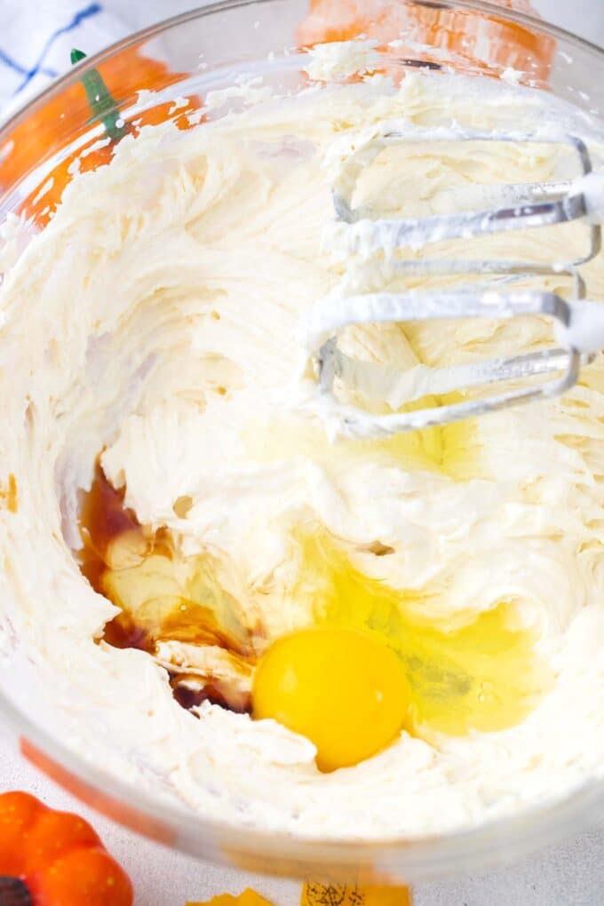 beating cream cheese with egg and vanilla