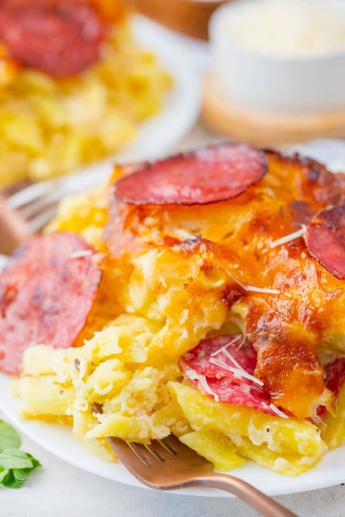A plate of creamy and cheesy white pizza casserole.