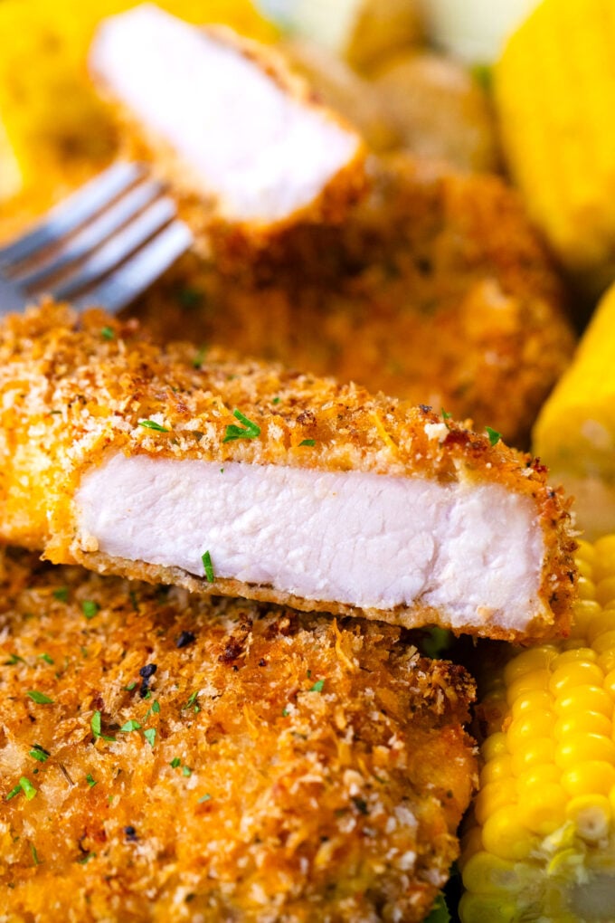 Sliced crispy baked pork chops revealing tender inside.