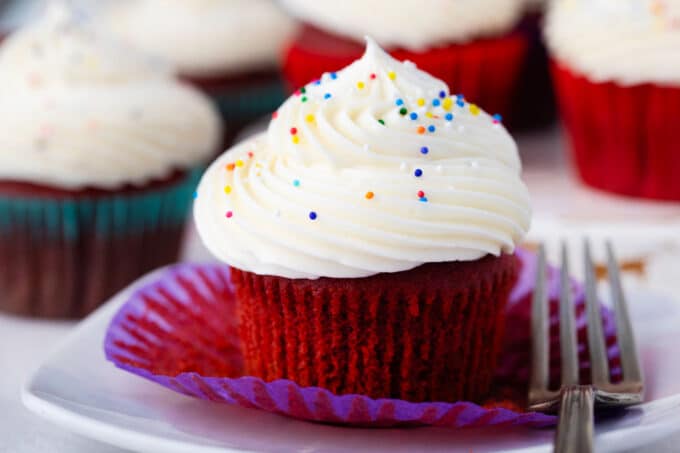 Red velvet cupcake topped with homemade cream cheese frosting.
