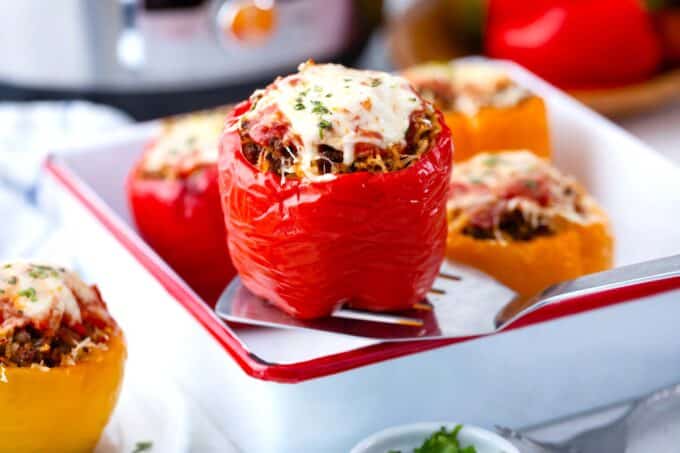 instant pot stuffed peppers in a baking dish topped with melted cheese