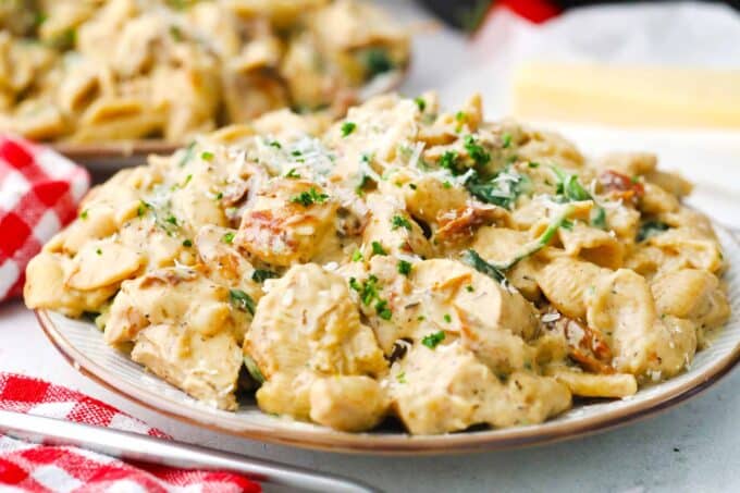 a plate of creamy instant pot tuscan chicken pasta