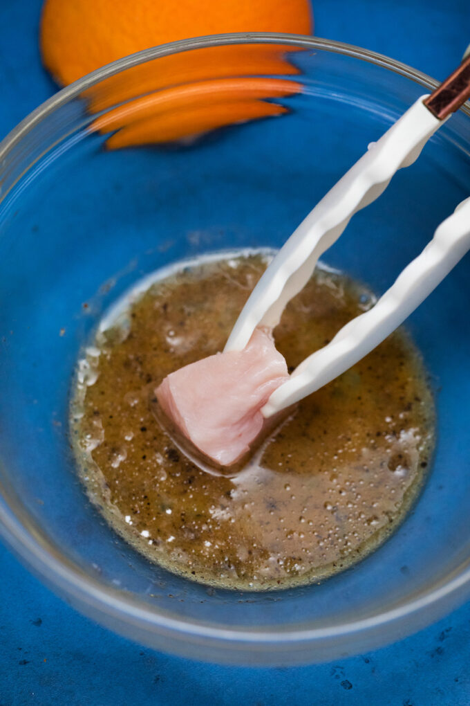 Dip chicken piece in beaten egg.