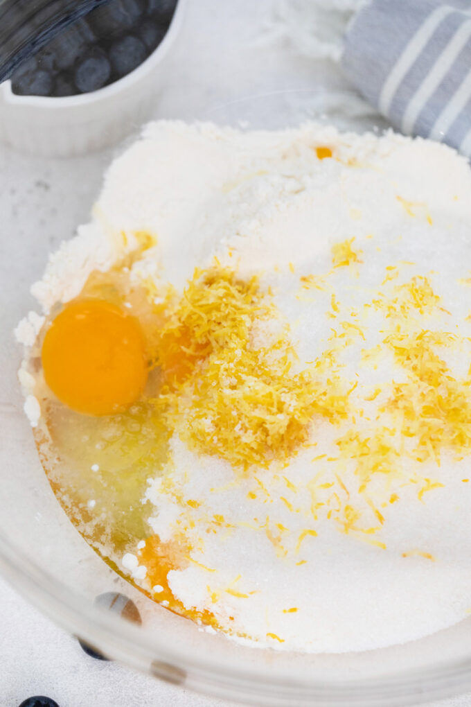 Egg, sugar, and lemon zest in a bowl.