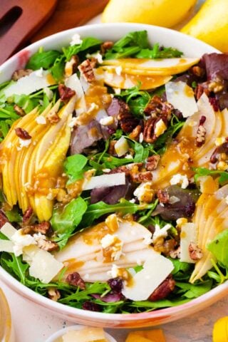 a bowl of homemade pear salad with fresh pears, pecans and cranberries