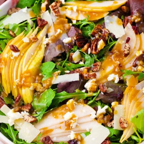 a bowl of homemade pear salad with fresh pears, pecans and cranberries