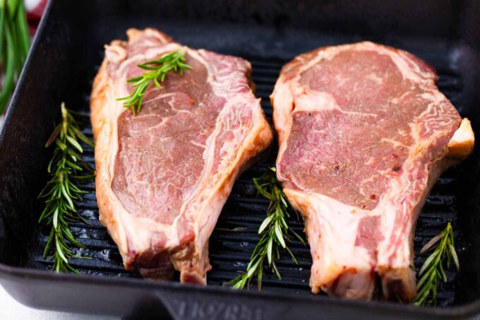 Asian style marinated steaks being cooked on a grill pan.