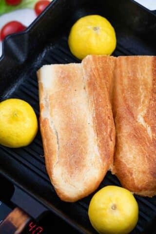 grilling lemons and baguette on a grill pan