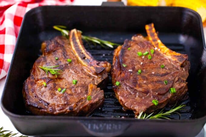 Cooking two ribeye steaks in a grill pan.