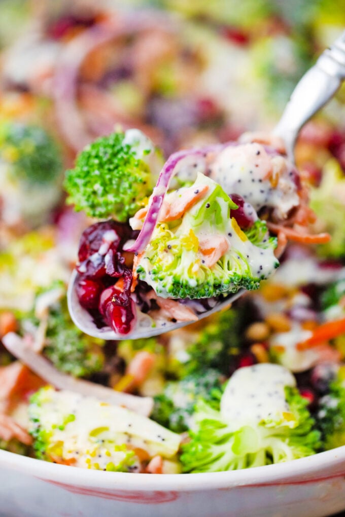 A serving spoon of broccoli salad.