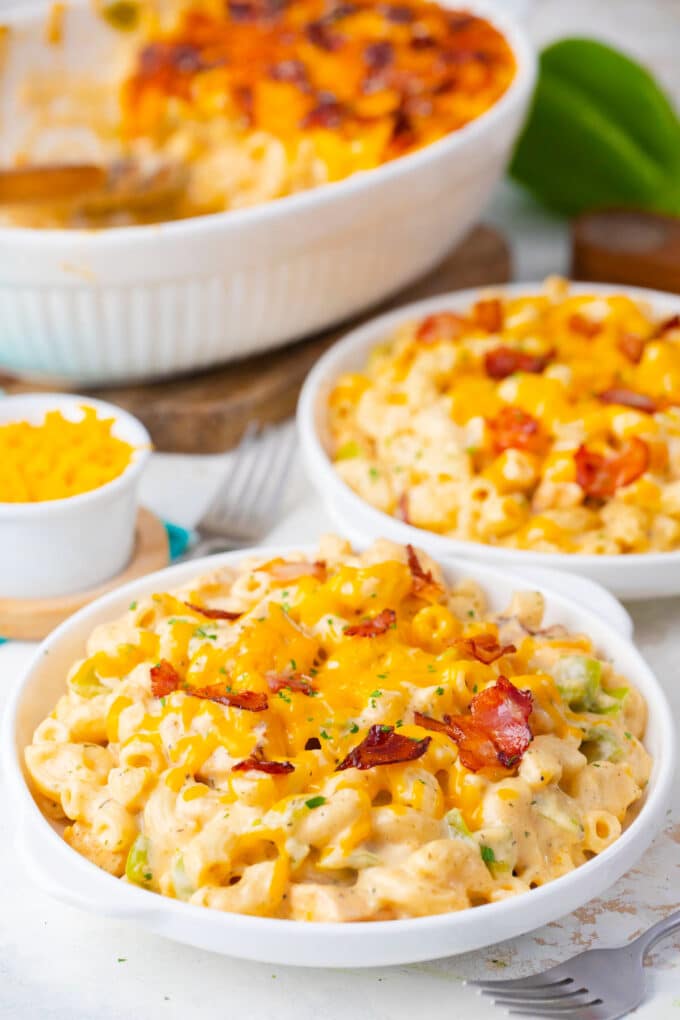 Two serving plates with cheesy cheesy crack chicken casserole.