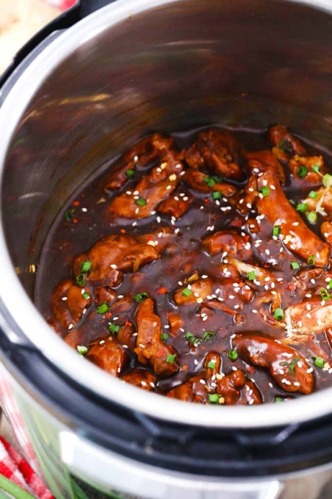 instant pot general tso chicken in the pot topped with sesame seeds