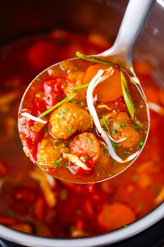 A ladle of hearty Instant Pot Italian meatball soup.
