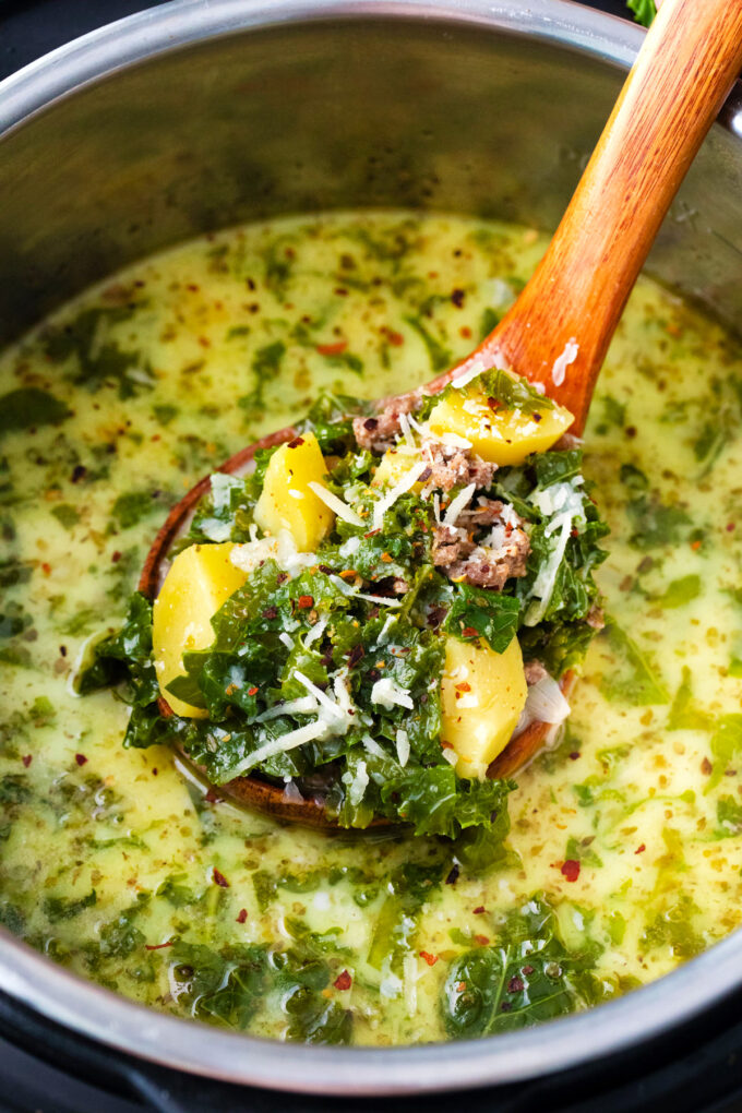 A ladle of creamy instant pot zuppa toscana.