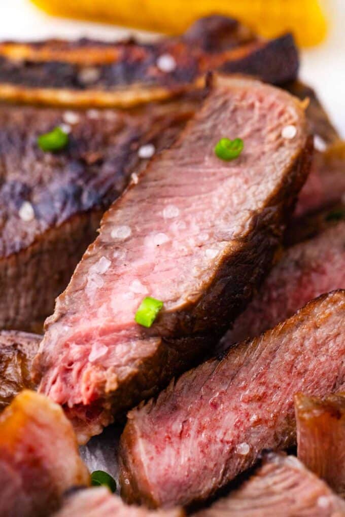 Close shot of slices of juicy Asian style grilled rib-eye steak.