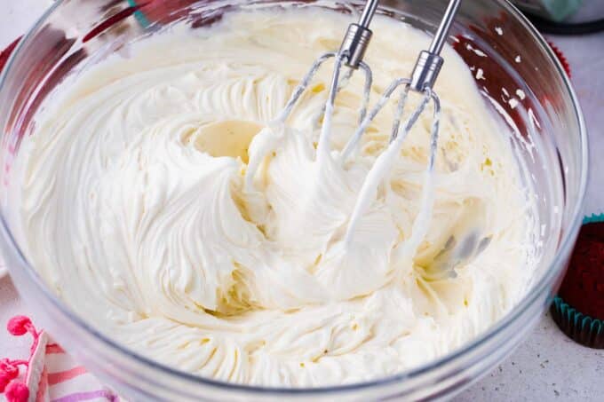A bowl of homemade, creamy cream cheese frosting.