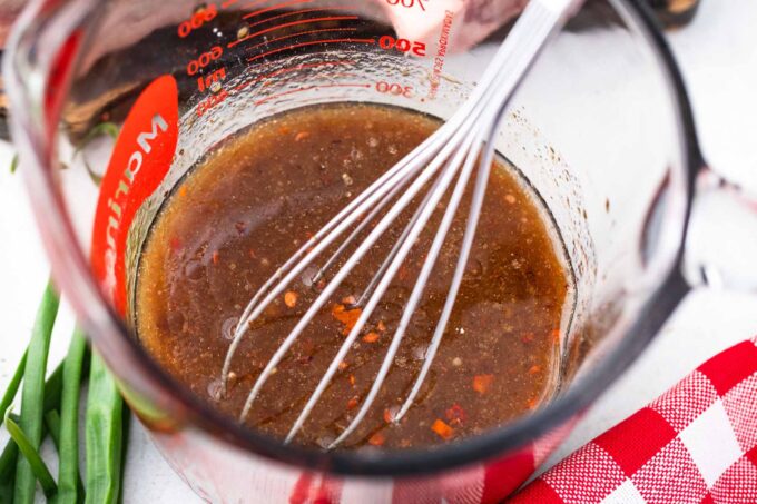 Asian style marinade for steak in a large measuring cup.
