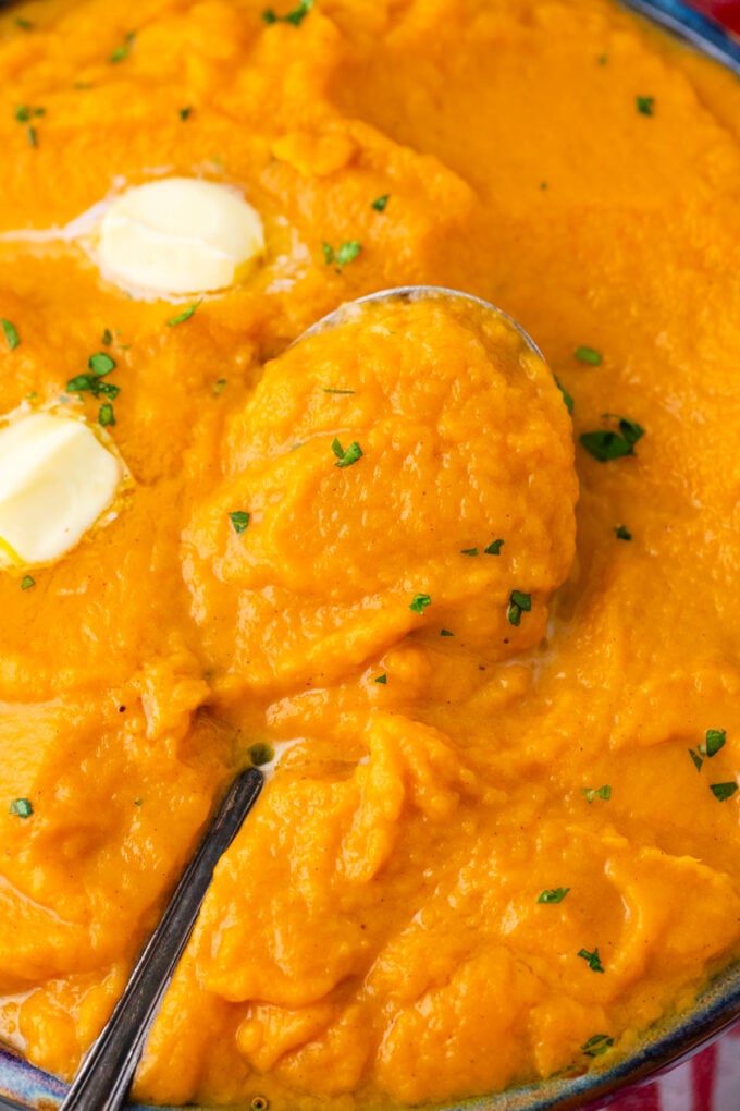 A spoonful of creamy and fluffy mashed sweet potatoes.