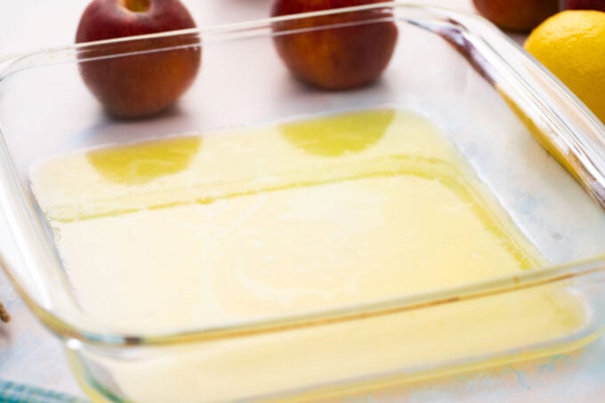 Melted butter in a baking dish.