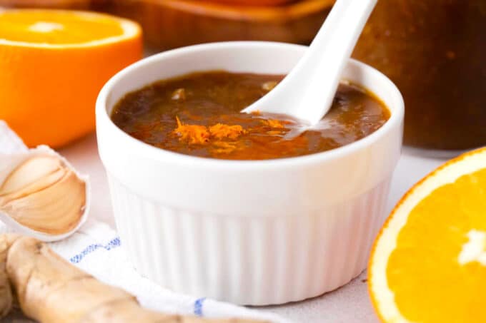 a ramekin with homemade orange sauce