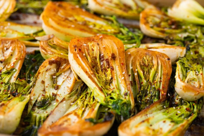 A pan of perfectly roasted bok choy with garlic.