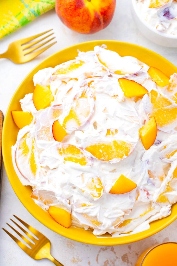 Overhead shot of a bowl of creamy peach cheesecake salad.