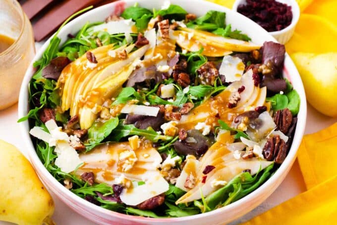 a bowl of pear salad with fresh sliced pears