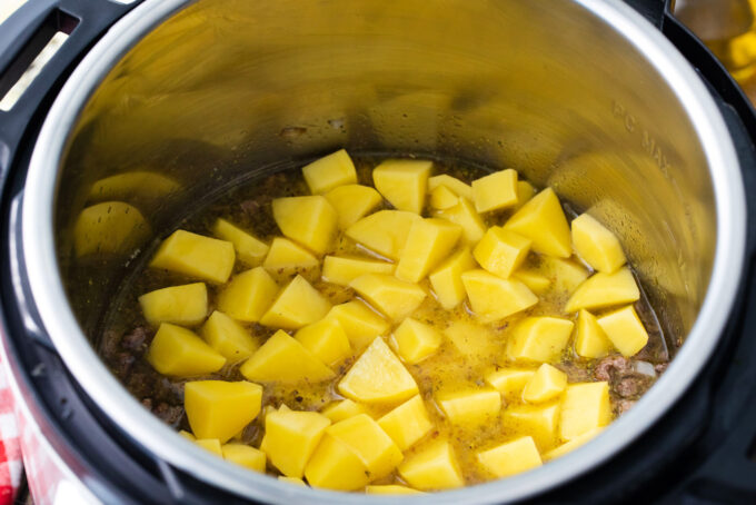 Potatoes, ground sausage, and broth in the instant pot.