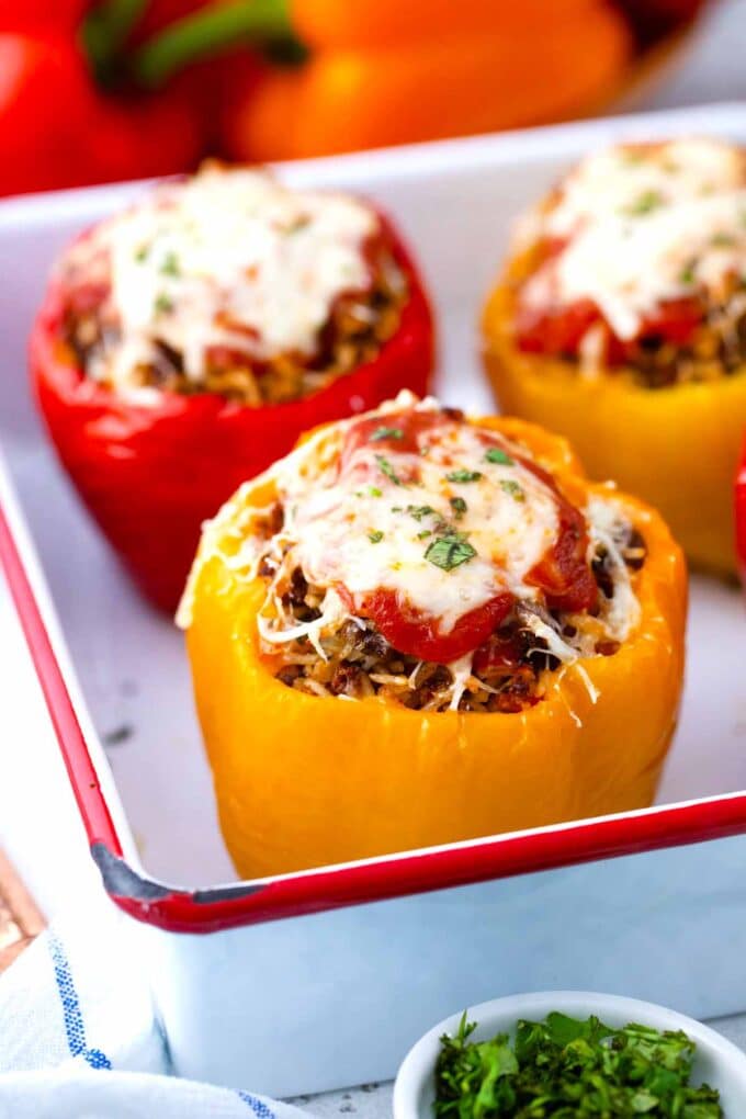 pressure cooker stuffed peppers topped with cheese in a baking dish