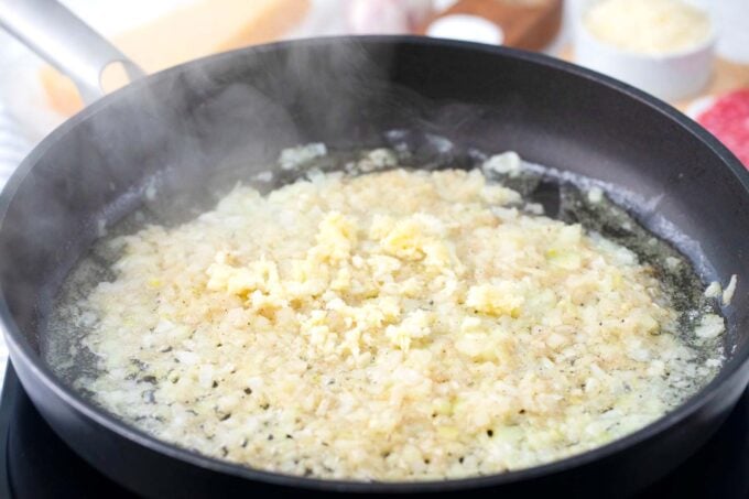 Sautéing garlic and onion in a skillet.