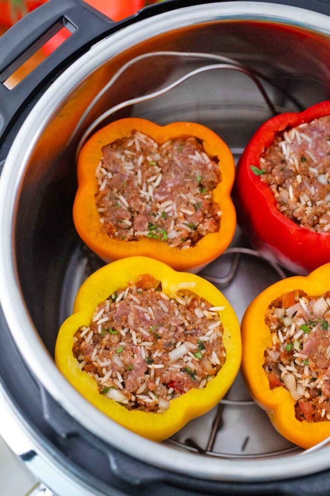 stuffed peppers on the trivet ready to be cooked