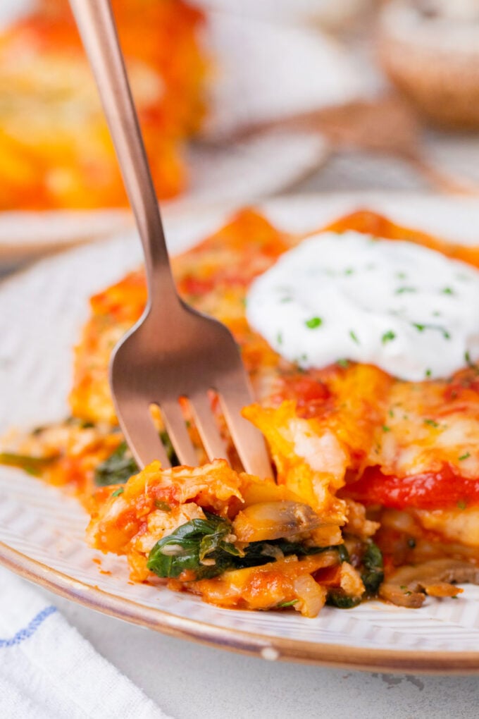 A forkful of veggie loaded chicken spinach lasagna.