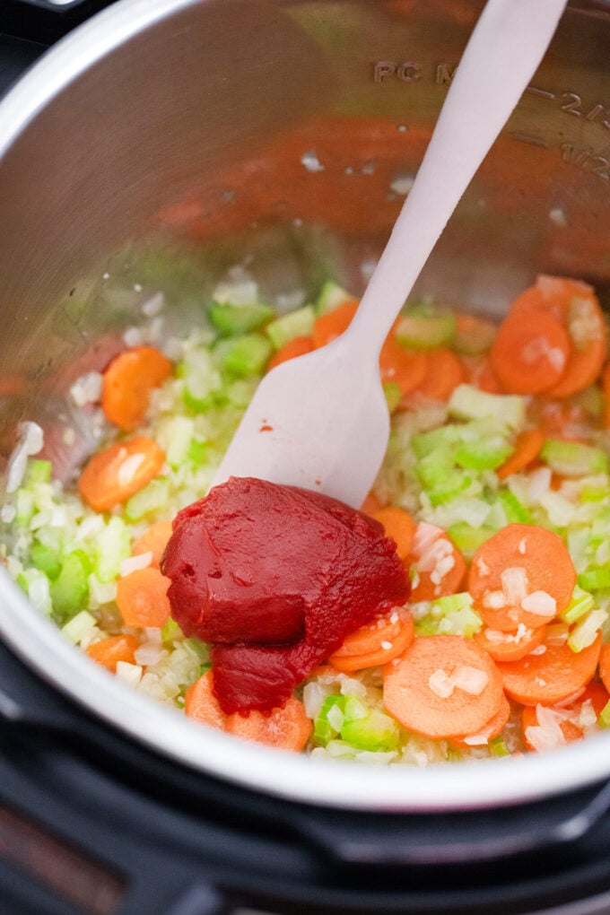 Sautéing veggies and tomato paste in the Instant Pot.