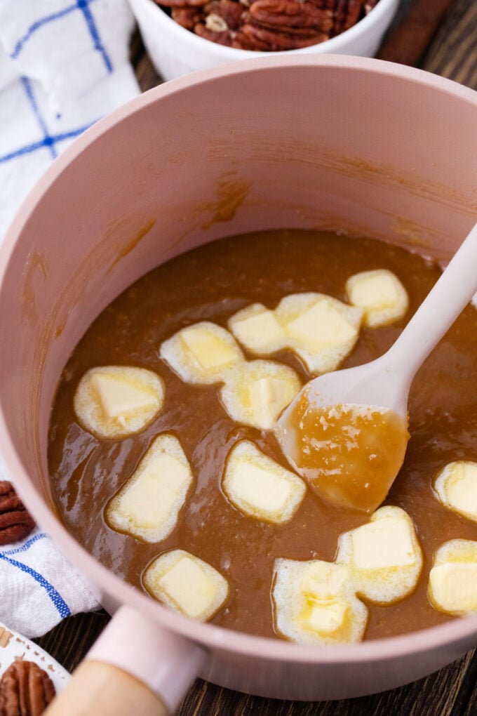 Stirring butter into pecan pie filling.